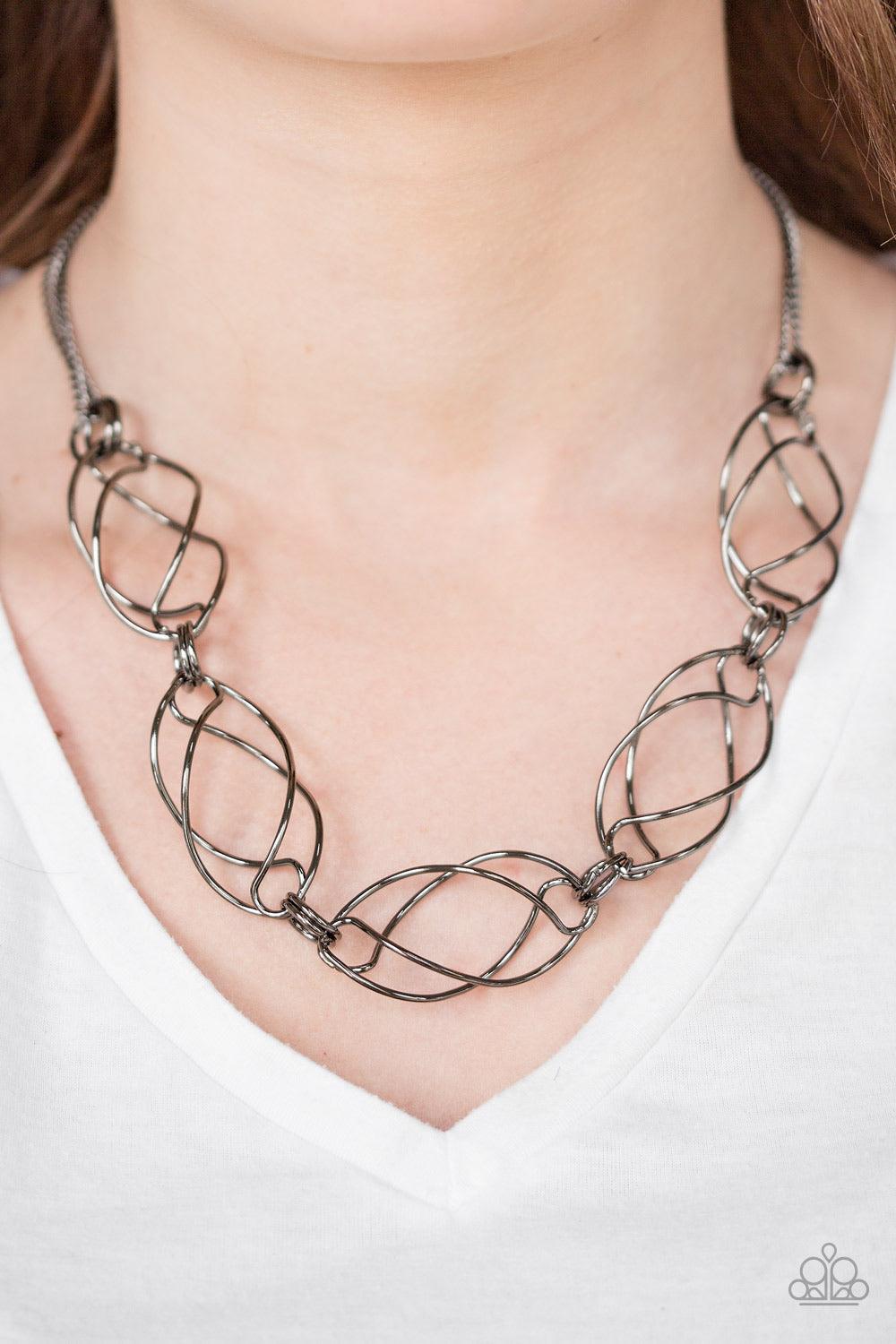 Paparazzi Accessories Burst Into Flames - Black Infused with doubled gunmetal chains, whirling gunmetal frames link below the collar for a bold industrial look. Features an adjustable clasp closure. Sold as one individual necklace. Includes one pair of ma