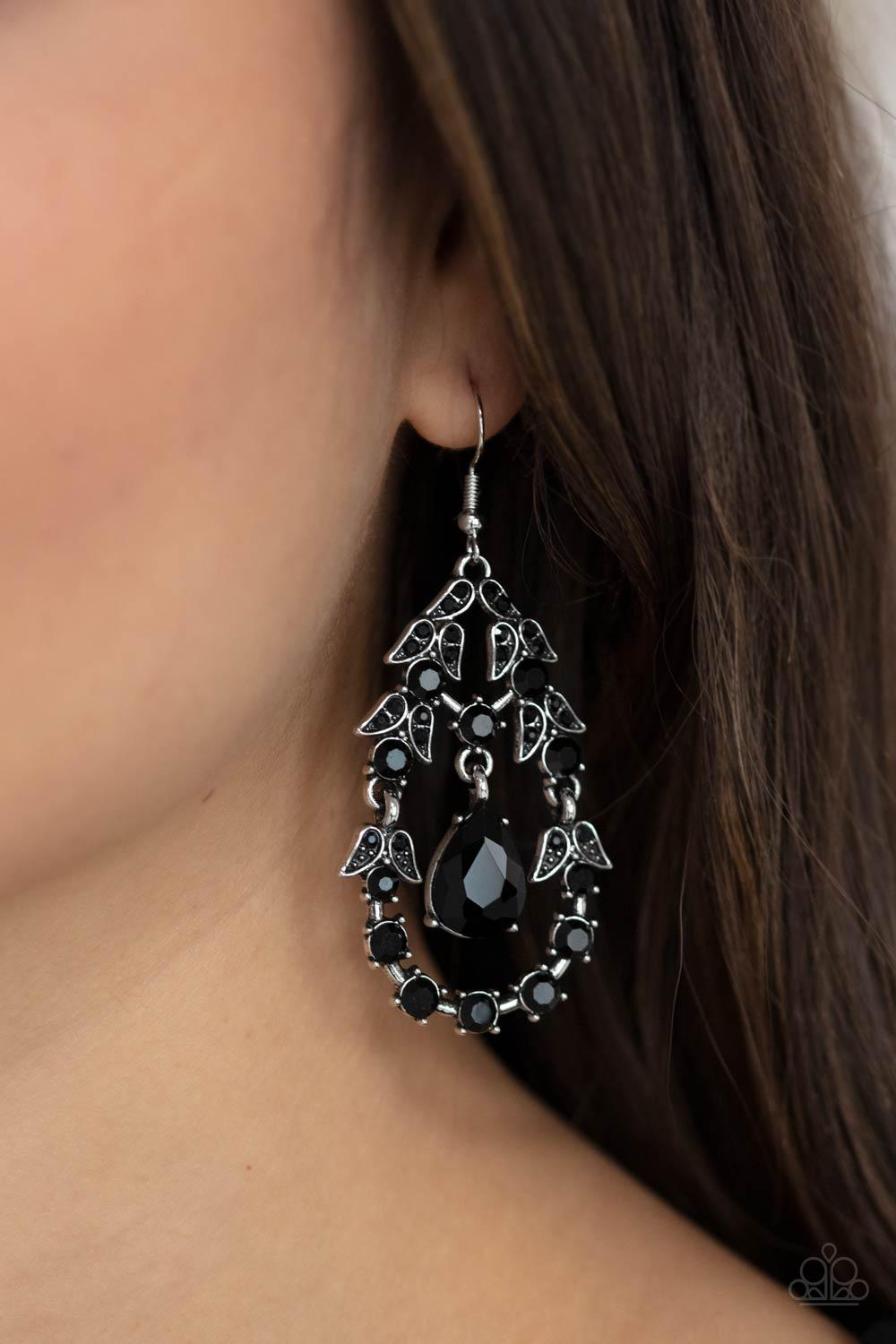 Paparazzi Accessories Garden Decorum - Black A solitaire black teardrop rhinestone swings from the top of an ornately hinged teardrop frame adorned in black rhinestone dotted leafy silver frames, creating a glamorous centerpiece. Earring attaches to a sta