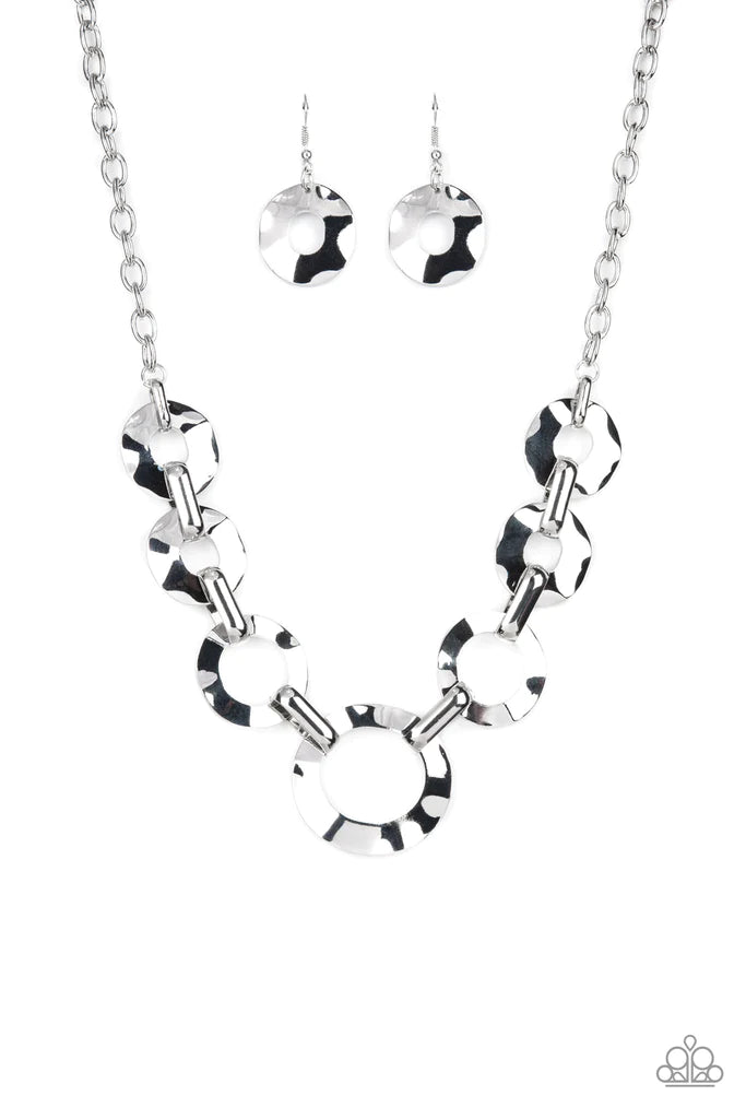 Paparazzi Accessories Mechanical Masterpiece - Silver Featuring hammered surfaces, crinkled silver rings gradually increase in size as they alternate with bold silver fittings below the collar for an intense industrial fashion. Features an adjustable clas