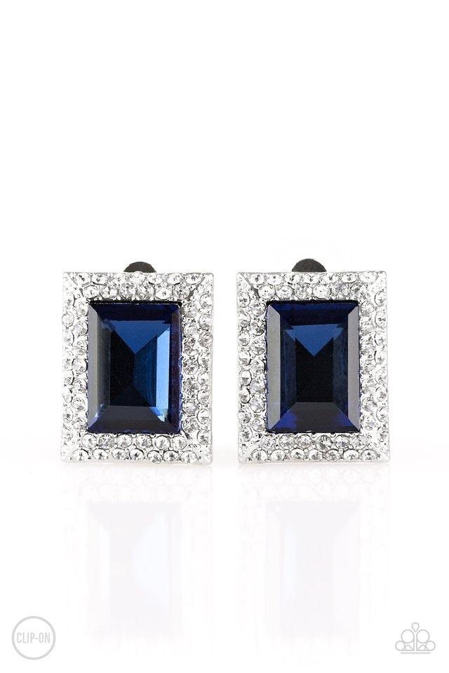 Paparazzi Accessories Crown Couture - Blue *Clip-On Featuring an elegant emerald style cut, a glittery blue gem is pressed into a rectangular frame radiating with sparkling white rhinestones for a regal fashion. Earring attaches to a standard clip-on fitt