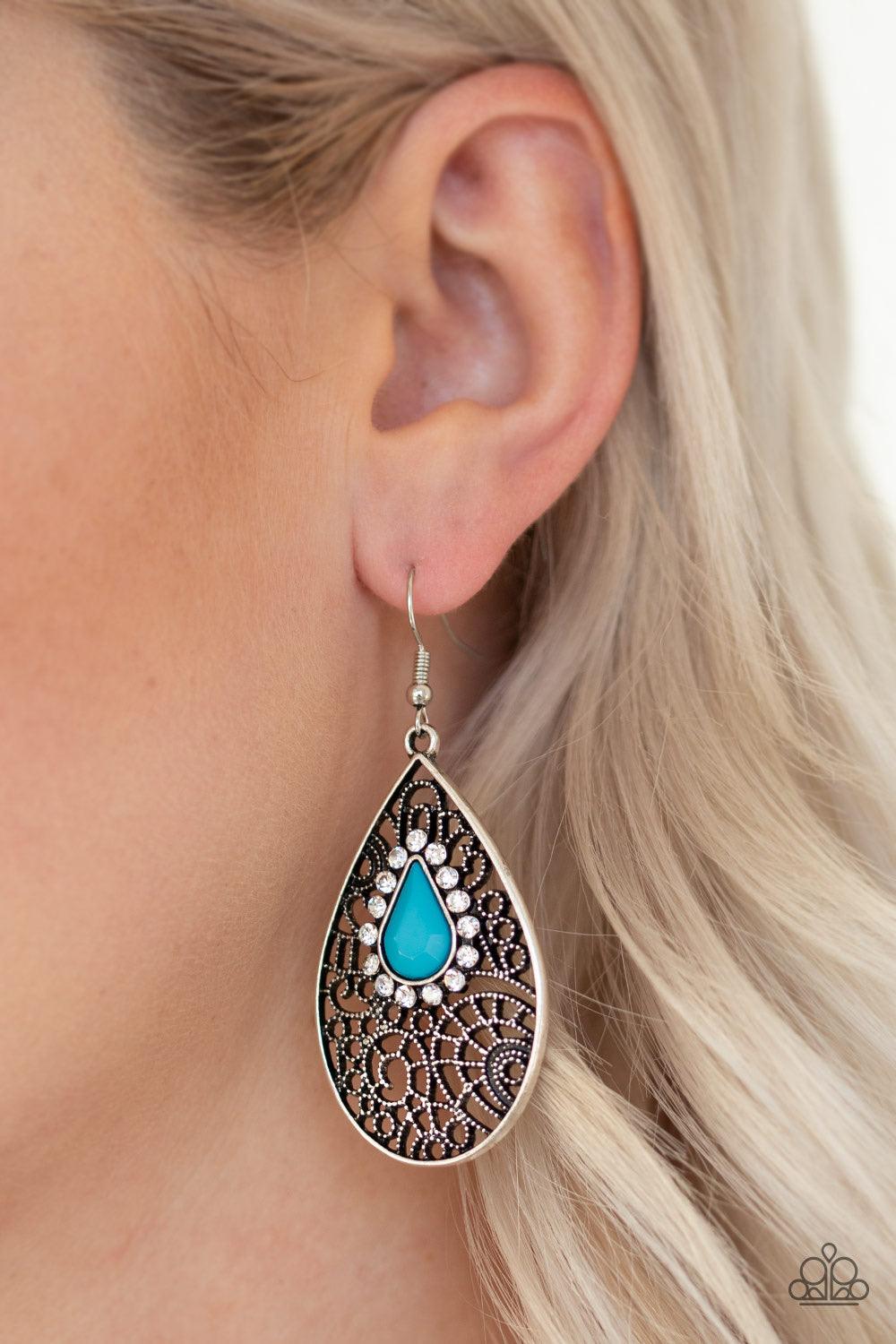 Paparazzi Accessories Modern Monte Carlo - Blue Ringed in glassy white rhinestones, a teardrop blue bead is pressed into a shimmery silver frame radiating with airy filigree for a refined fashion. Earring attaches to a standard fishhook fitting. Jewelry