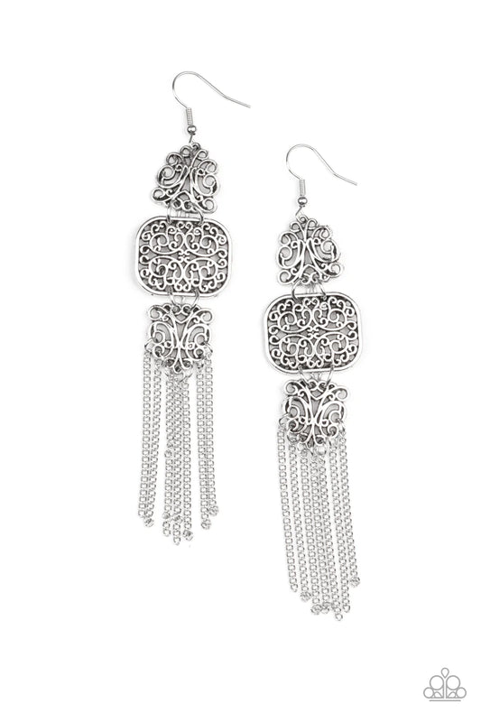 Paparazzi Accessories Eastern Elegance - Silver Filled with vine-like filigree, a trio of mismatched silver frames delicately link into a stacked lure. A curtain of dainty silver chains stream from the bottom of the display, adding playful movement to the