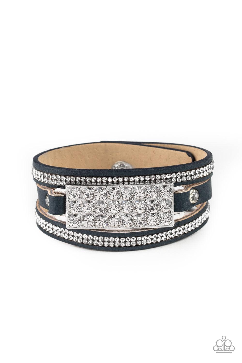 Paparazzi Accessories Shockingly Sparkly - Black A thick blue leather band is spliced into three separate strands. Encrusted in rows of glassy white rhinestones, two glittery strands flank a blinding silver buckle encrusted in oversized white rhinestones