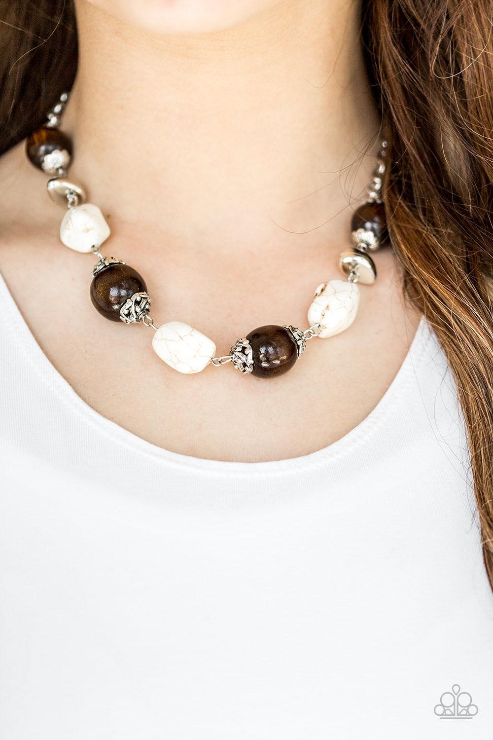 Paparazzi Accessories Earth Goddess - White Infused with ornate silver accents, refreshing white stones and round wooden beads trickle along a shimmering silver chain, creating an artisanal statement piece that falls just below the collar. Features an adj