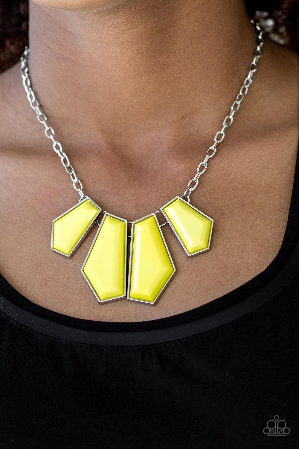 Paparazzi Accessories Get Up and GEO - Yellow Featuring emerald-style cuts, faceted yellow beads are pressed into sleek silver frames. The colorful frames join at the bottom of a shimmery silver chain, creating a bold geometric fringe below the collar. Fe