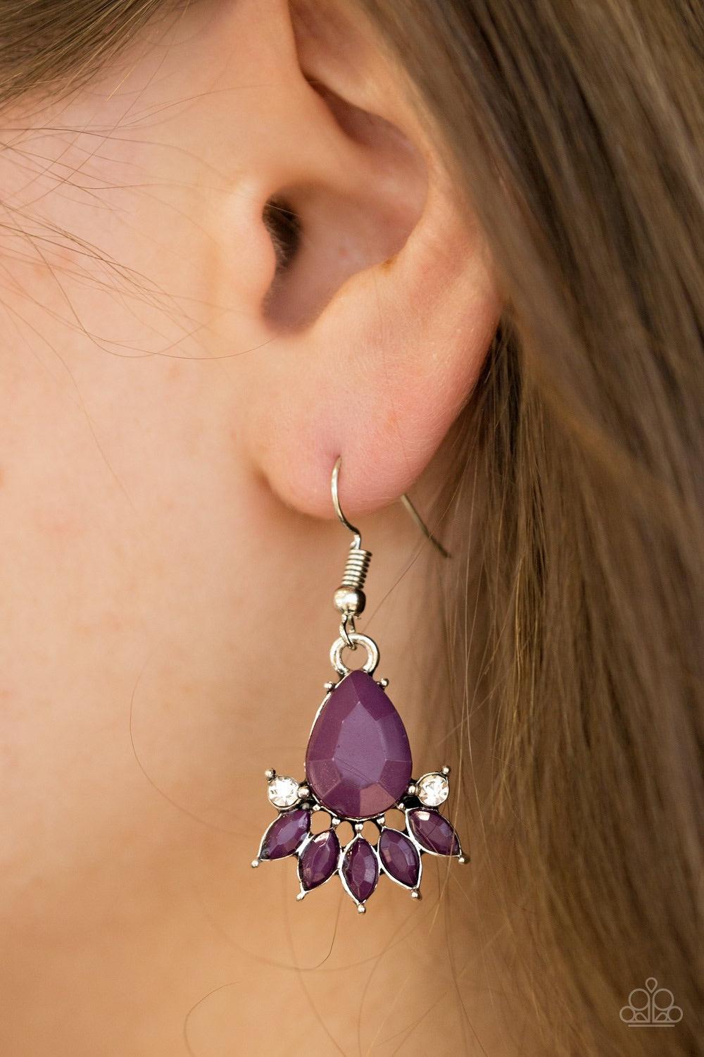 Paparazzi Accessories Meant To BEAD - Purple Faceted purple beads fan out from a larger teardrop bead in a regal fashion. Dainty white rhinestones dot the sides, adding an extra splash of shimmer to the flirty palette. Earring attaches to a standard fishh