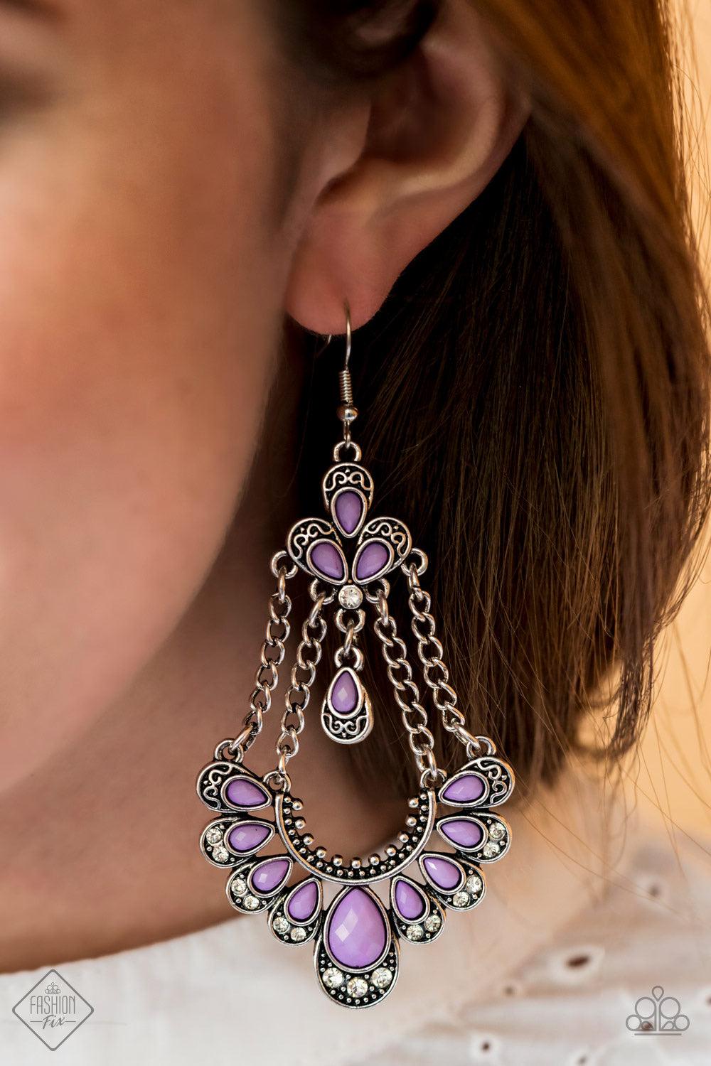 Paparazzi Accessories Unique Chic ~Purple Faceted purple teardrop-shaped beads are pressed into silver fittings decorated in filigree and texture. The beads fan out along the bottom of a curved silver bar that is suspended from strands of silver chain. A