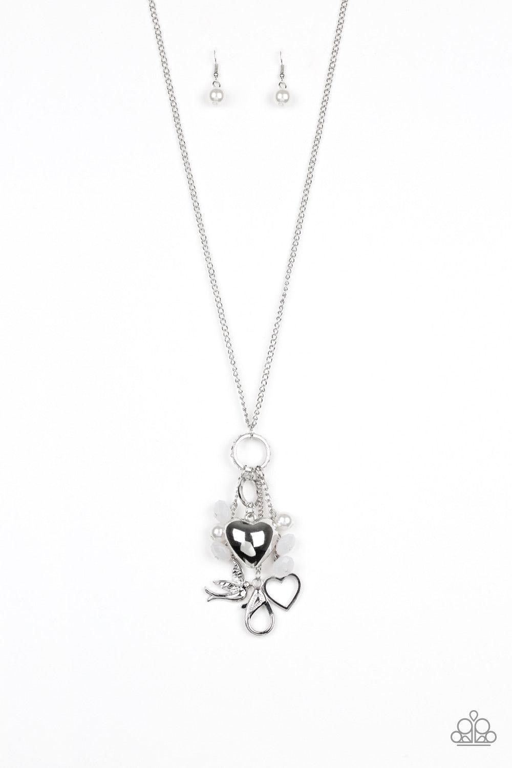 Paparazzi Accessories I Will Fly - White A silver bird charm, silver heart charms, and collection of white pearls and opaque crystal-like beads swing from the bottom of a lengthened silver chain for whimsically clustered look. A lobster clasp hangs from t