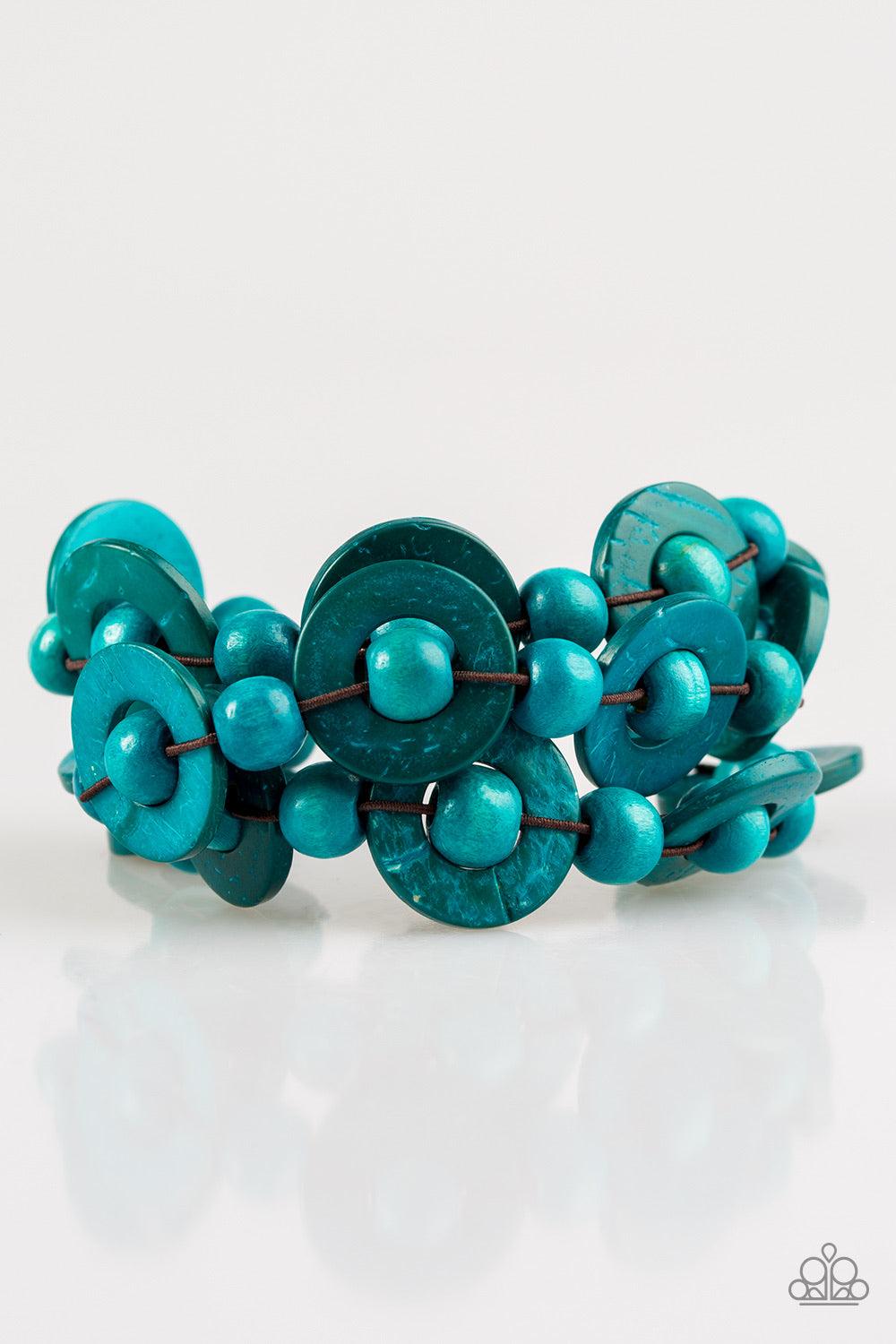 Paparazzi Accessories Cancun Catch ~Blue Brushed in refreshing blue finishes, wooden rings and beads are knotted in place along three stretchy strands, creating summery layers around the wrist. Features a button loop closure. Sold as one individual bracel