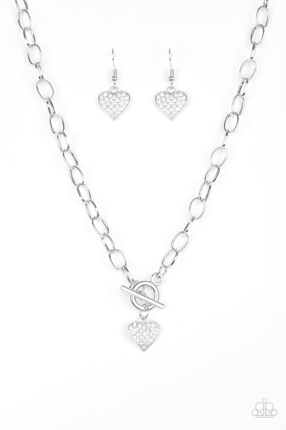 Paparazzi Accessories Harvard Hearts - White Encrusted in glassy white rhinestones, a dainty silver heart swings from the bottom of a glistening silver chain for a classic look. Features a toggle closure. Jewelry