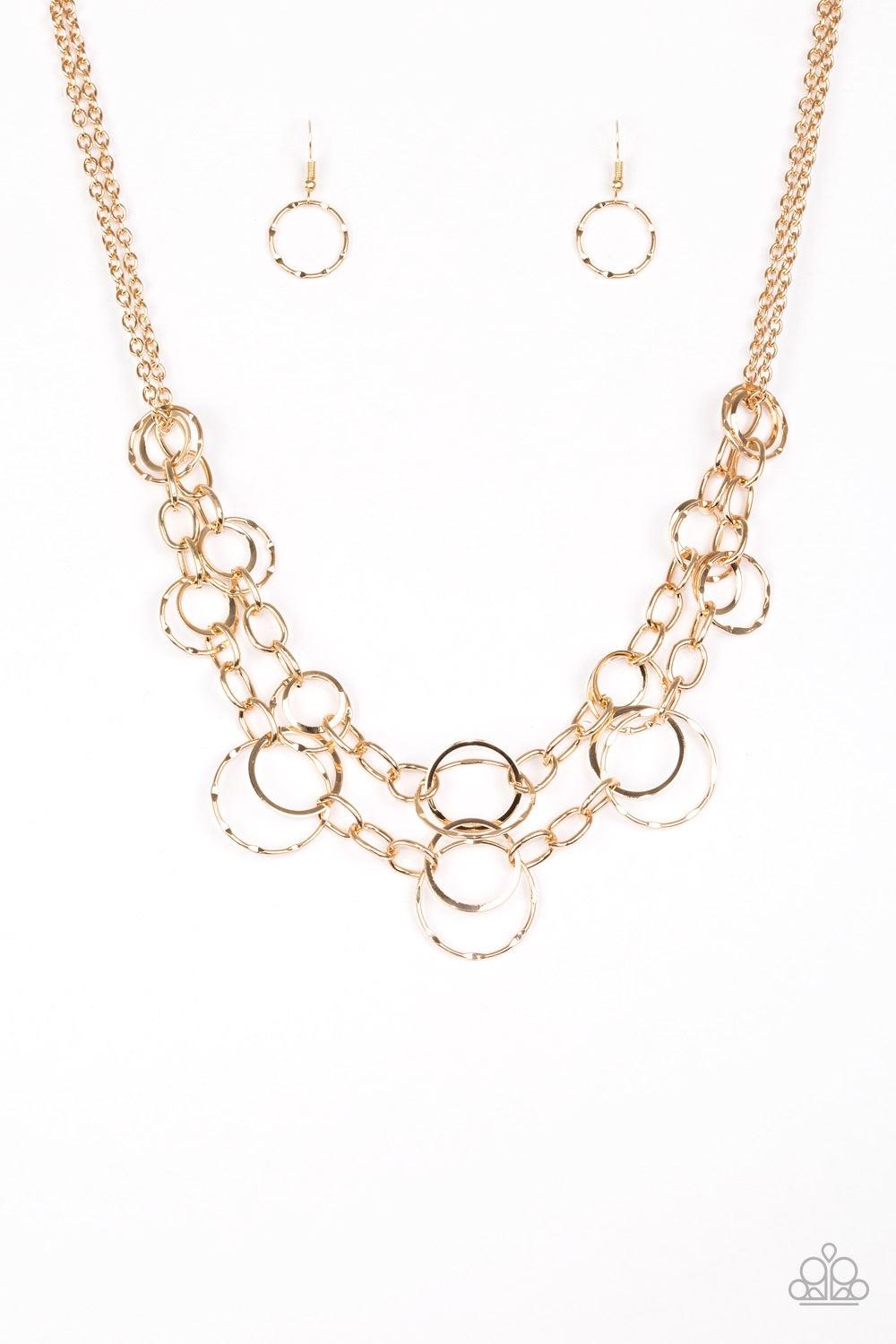 Paparazzi Accessories Urban Center - Gold Mismatched gold hoops and rings link into two shimmery rows below the collar for a bold industrial look. Features an adjustable clasp closure. Jewelry