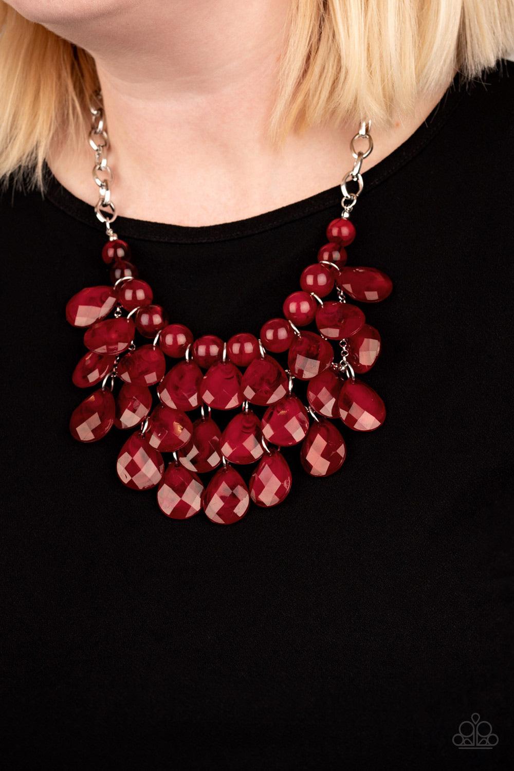 Paparazzi Accessories Sorry To Burst Your Bubble - Red Attached to a bold silver chain, round opaque red beads are threaded along an invisible wire below the collar. Attached to a net of silver chains, faceted opaque teardrops cascade from the bottom of t