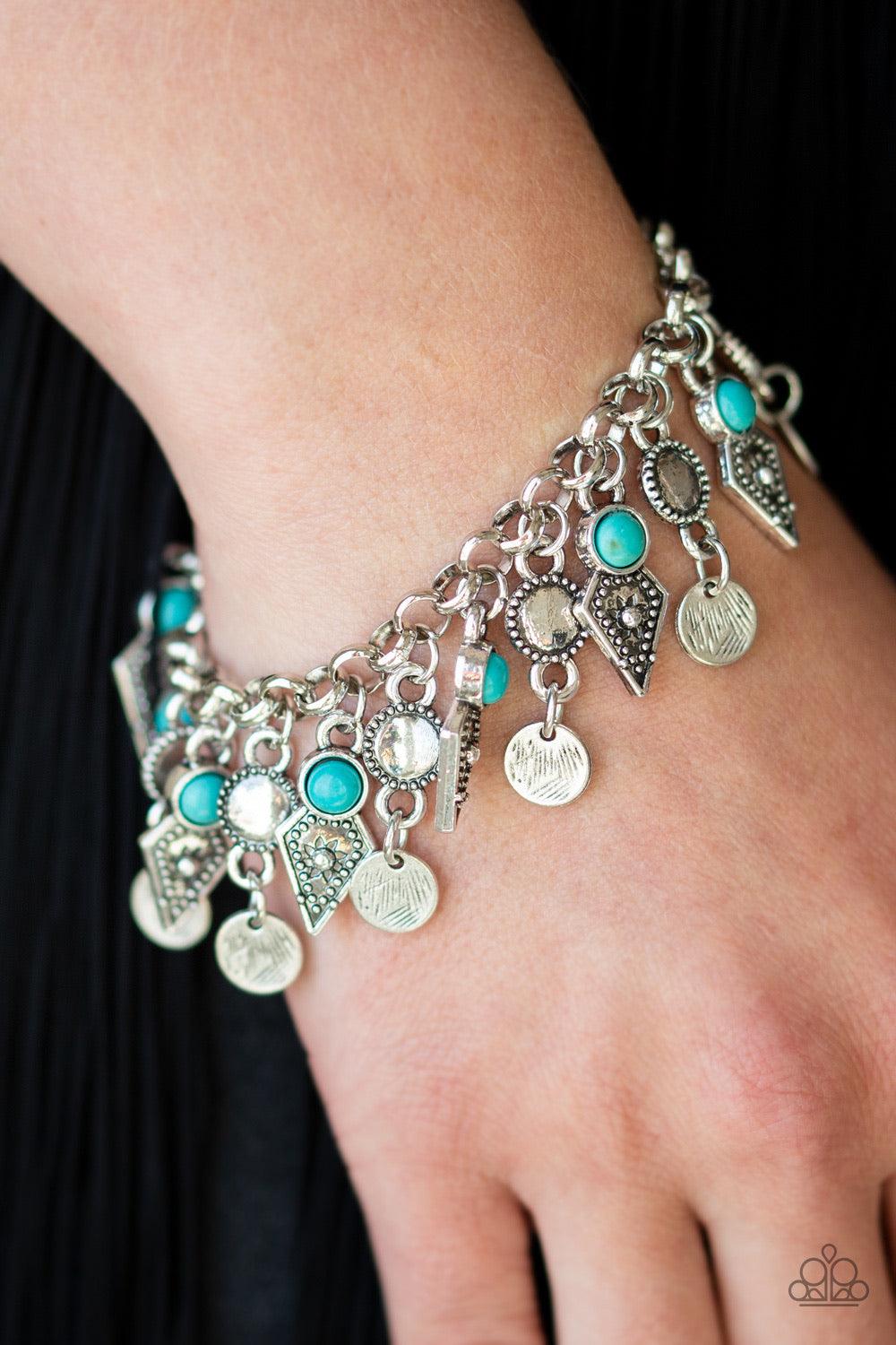 Paparazzi Accessories Triassic Trade Route ~Blue Featuring studded detail and refreshing turquoise stone accents, mismatched silver frames swing from the bottom of a bold silver chain, creating a flirty fringe around the wrist. Features an adjustable clas