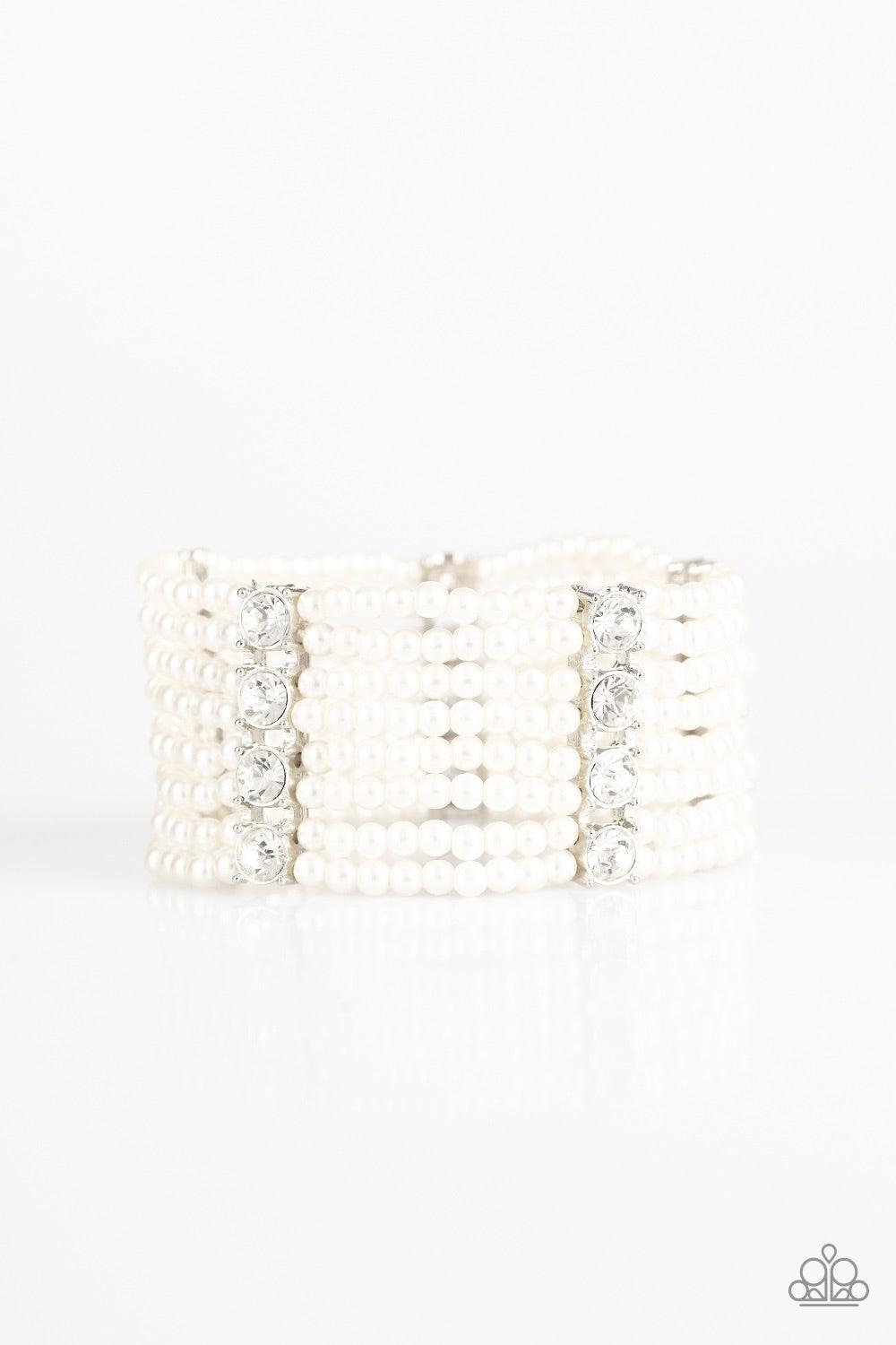 Paparazzi Accessories Get In Line - White Held together by stacked white rhinestone encrusted frames, a collection of dainty white pearls are threaded along stretchy bands around the wrist for a timeless twist. Jewelry