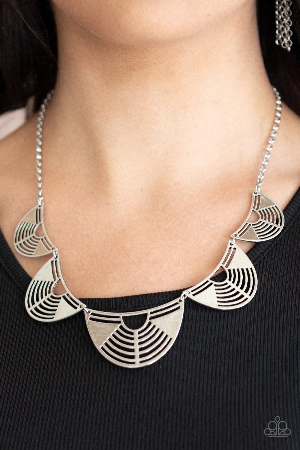 Paparazzi Accessories Record-Breaking Brilliance - Silver Featuring airy geometric cutouts, antiqued silver crescent shaped frames increase in size as they delicately link below the collar, creating an edgy fringe. Features an adjustable clasp closure. So