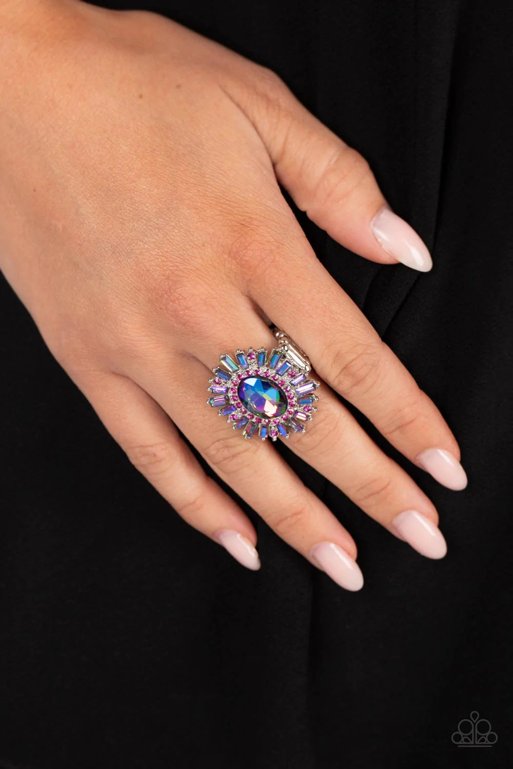 Paparazzi Accessories Astral Attitude - Pink A large blue iridescent rhinestone sparkles inside a ring of dainty fuchsia rhinestones. Emerald cut blue iridescent and fuchsia rhinestones fan out from the dazzling center, exploding into a stellar centerpiec