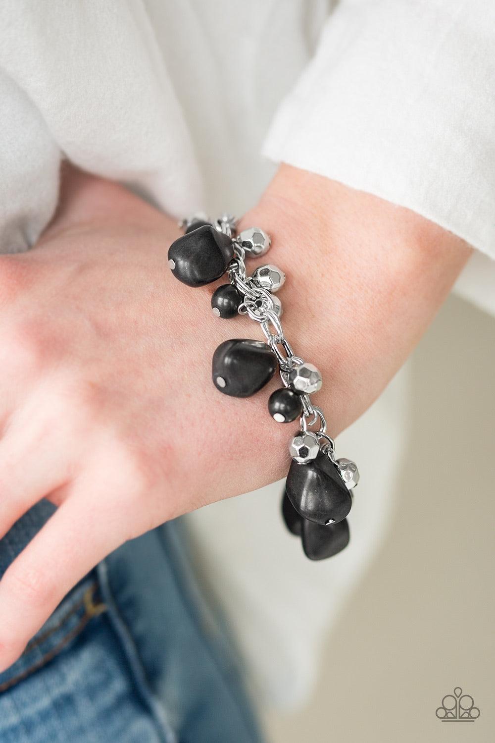 Paparazzi Accessories Practical Paleo - Black Featuring round and asymmetrical cuts, refreshing black stones trickle from the bottom of a double chain-linked chain. Faceted silver beads trickle between the stones, adding a splash of metallic shimmer to th