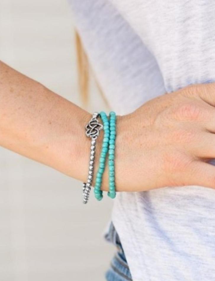 Paparazzi Accessories Collect Moments - Blue Vivacious blue/turquoise beads and classic silver beads are threaded along elastic stretchy bands, creating colorful layers across the wrist. Brushed in an antiqued shimmer, an airy heart charm adorns the cente