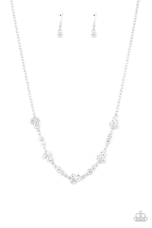 Paparazzi Accessories Gorgeously Glistening - White Encased in sleek silver frames, dainty pairs and trios of glittery white rhinestones delicately link into a timeless display below the collar. Features an adjustable clasp closure. Sold as one individual