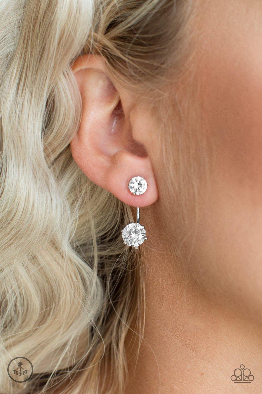 Paparazzi Accessories Starlet Squad - White A solitaire white rhinestone attaches to a double-sided post, designed to fasten behind the ear. Dotted with an oversized white rhinestone, the double-sided post peeks out beneath the ear for a dramatic look. Ea