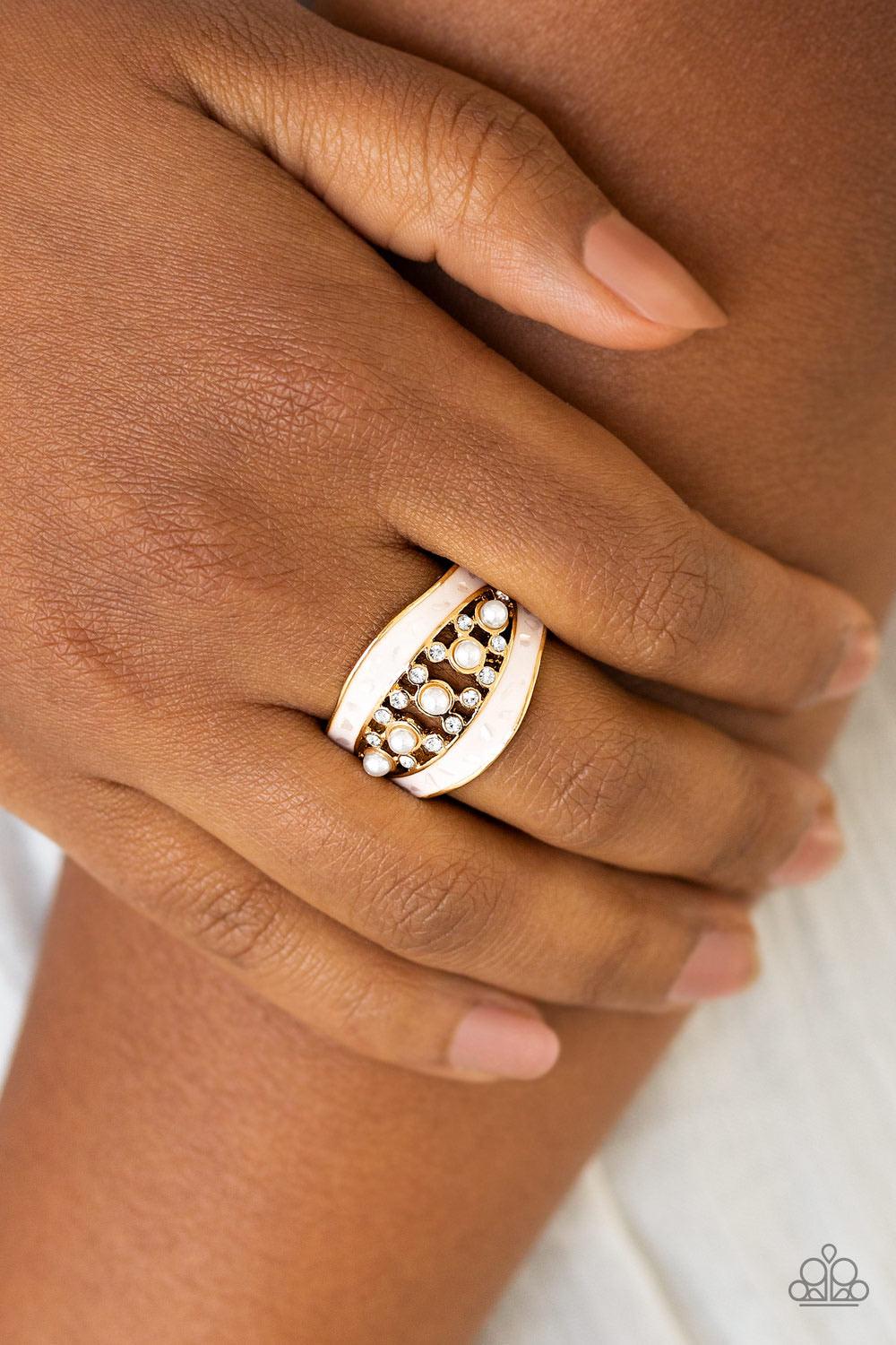 Paparazzi Accessories Royal Treasury - Gold Flecked in shell-like iridescence, shimmery white bands join around a bubbly pearl drop and white rhinestone center for a refined look. Features a stretchy band for a flexible fit. Sold as one individual ring. J