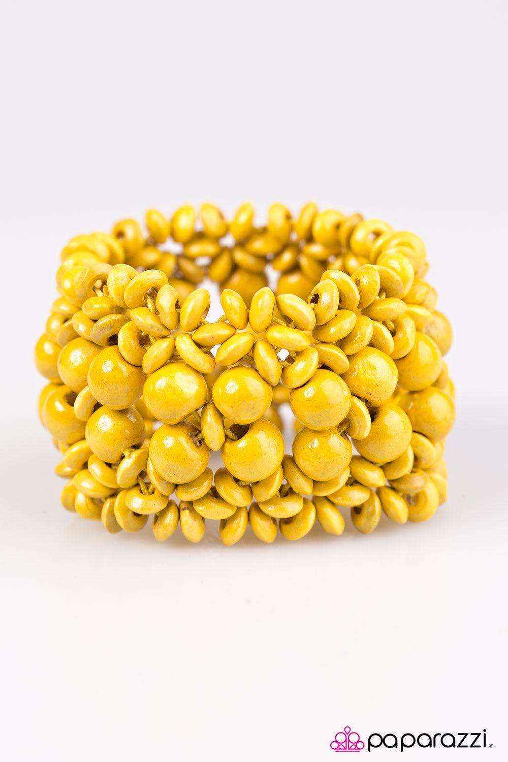 Paparazzi Accessories Tropical Bliss - Yellow Yellow wooden accents are threaded along elastic stretchy bands, creating an ornate bracelet. Rounded yellow wooden beads line the center of the summery pattern for a bold finish. Jewelry