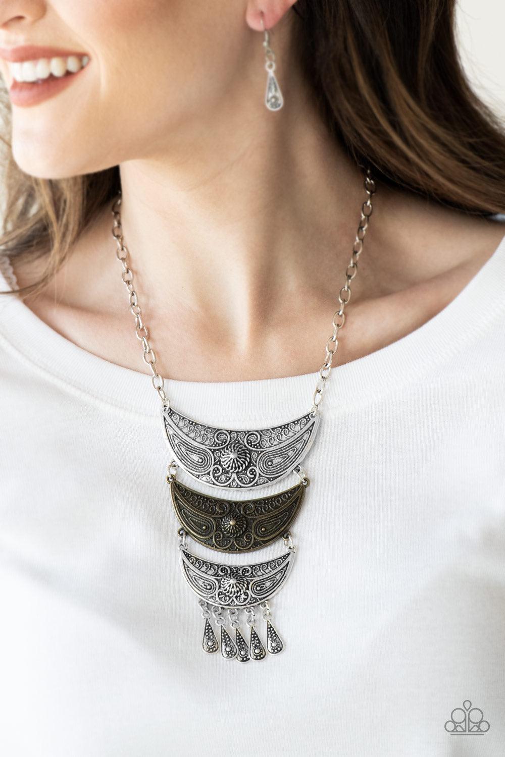 Paparazzi Accessories Go STEER-Crazy - Multi Gradually decreasing in size down the chest, decorative silver and brass crescent plates connect into a bold pendant. Dotted in dainty studs, teardrop silver frames swing from the bottom of the tribal inspired