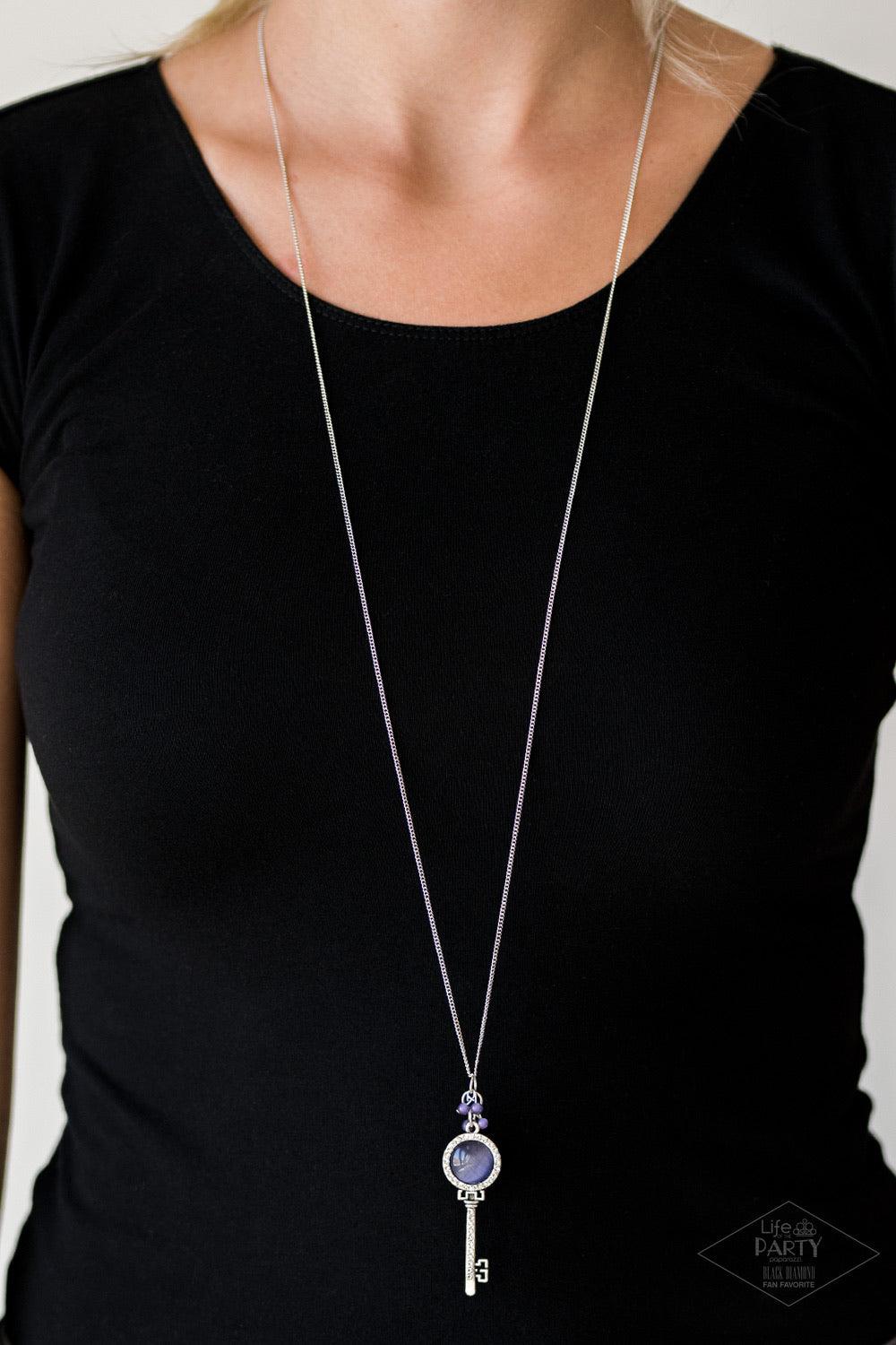 Paparazzi Accessories Unlock Every Door ~Purple A luminescent purple cat's eye stone is pressed into a silver key charm, creating a colorful pendant. Infused with iridescent purple cat's eye beading, the silver key is encrusted in glittery white rhineston