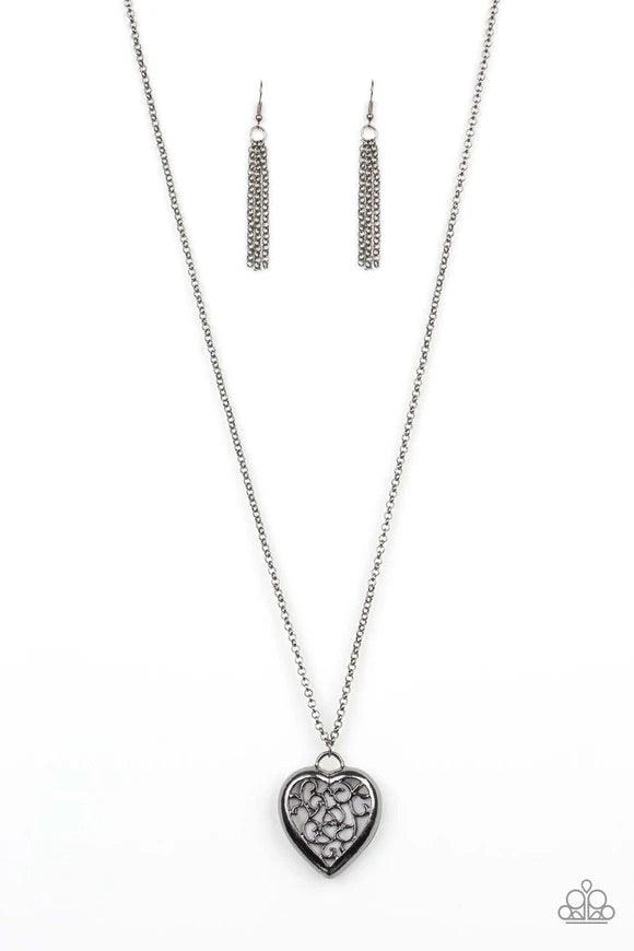 Paparazzi Accessories Victorian Valentine - Black Featuring vine-like filigree, a dramatic locket-like heart swings from the bottom of a lengthened gunmetal chain for a vintage inspired look. Features an adjustable clasp closure. Sold as one individual ne