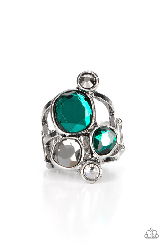 Paparazzi Accessories Demandingly Duchess - Green A collection of sparkling green and smoldering hematite gems in varying sizes, accented by a single white rhinestone, forms an asymmetrical cluster atop the finger. Set in sleek silver frames over airy sil