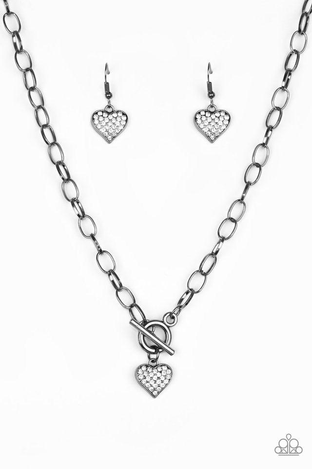 Paparazzi Accessories Harvard Hearts - Black Encrusted in glassy white rhinestones, a dainty gunmetal heart swings from the bottom of a glistening gunmetal chain for a classic look. Features a toggle closure. Jewelry