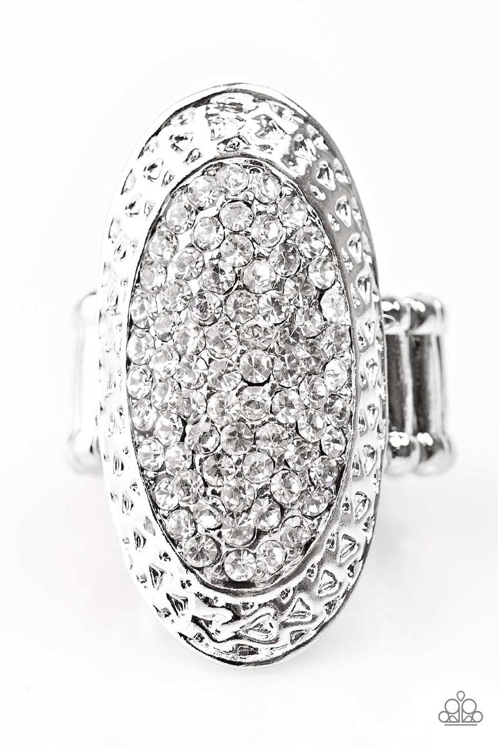 Paparazzi Accessories Ka-POW! - Silver Hammered in light catching texture, a sleek oval frame trickles down the finger in an elegant fashion. Encrusted in brilliant white rhinestones, the glitzy centerpiece creates an undeniable statement piece. Features