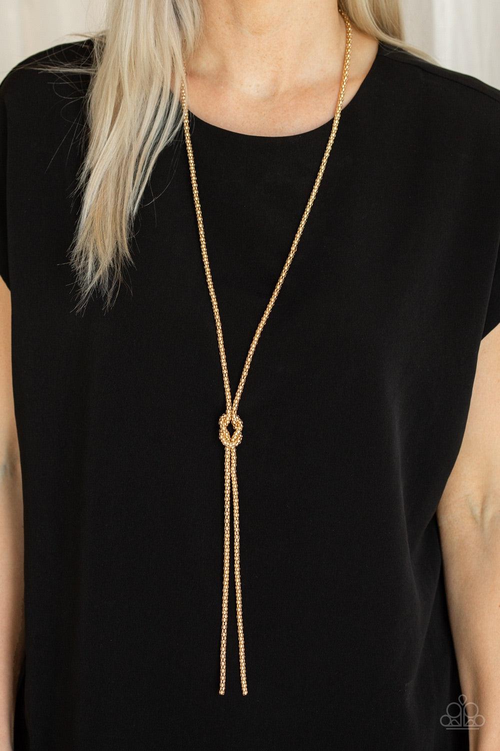 Paparazzi Accessories Born Ready - Gold A glistening strand of lengthened gold popcorn chain delicately knots at the chest, creating an edgy tasseled pendant. Features an adjustable clasp closure. Jewelry