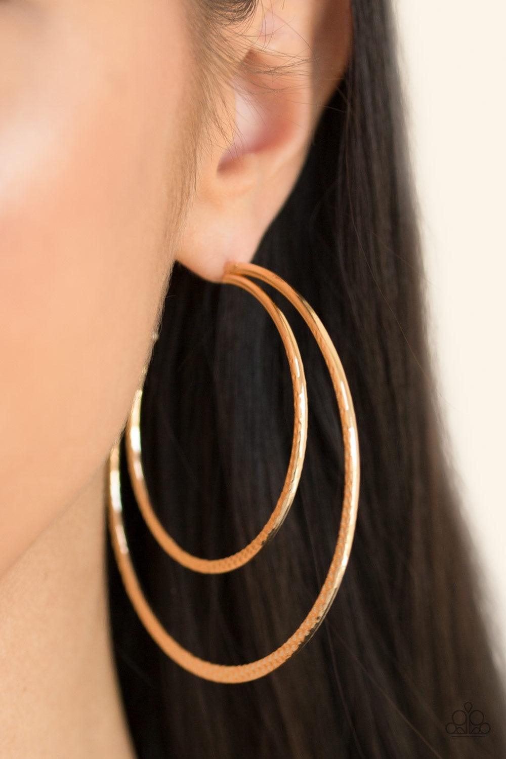 Paparazzi Accessories Drop It Like It’s HAUTE - Gold Featuring diamond-cut textures, two glistening gold bars curl into a bold hoop for a flawless finish. Earring attaches to a standard post fitting. Hoop measures 2 3/4” in diameter. Jewelry