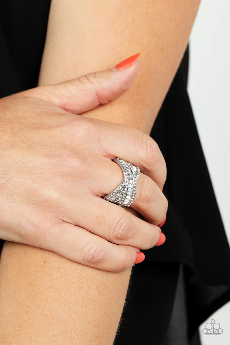 Paparazzi Accessories Status Update - White Two rows of glittering emerald cut white rhinestones crisscross across the finger inside silver frames lined with dainty white rhinestones resulting in a glamorously modern finish. Features a stretchy band for a