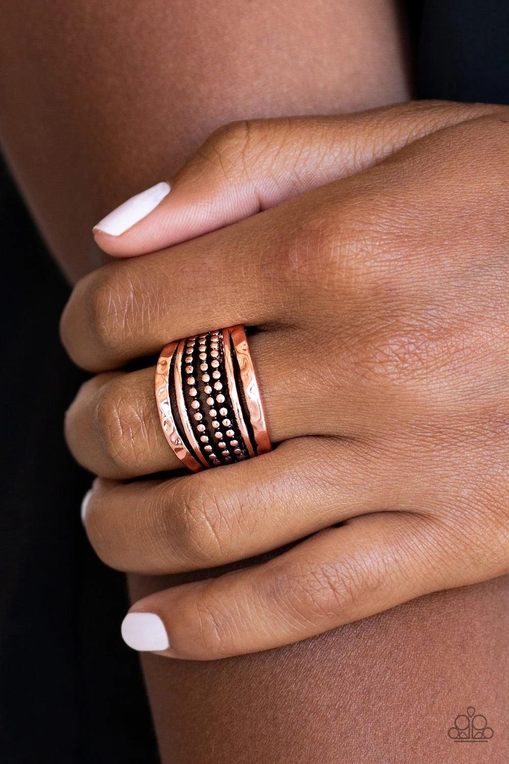 Paparazzi Accessories Trailblazin Trails - Copper Delicately hammered in shimmering detail, two copper bands flank rows of smooth and dotted bands for a collision of glistening textures. Features a stretchy band for a flexible fit. Sold as one individual