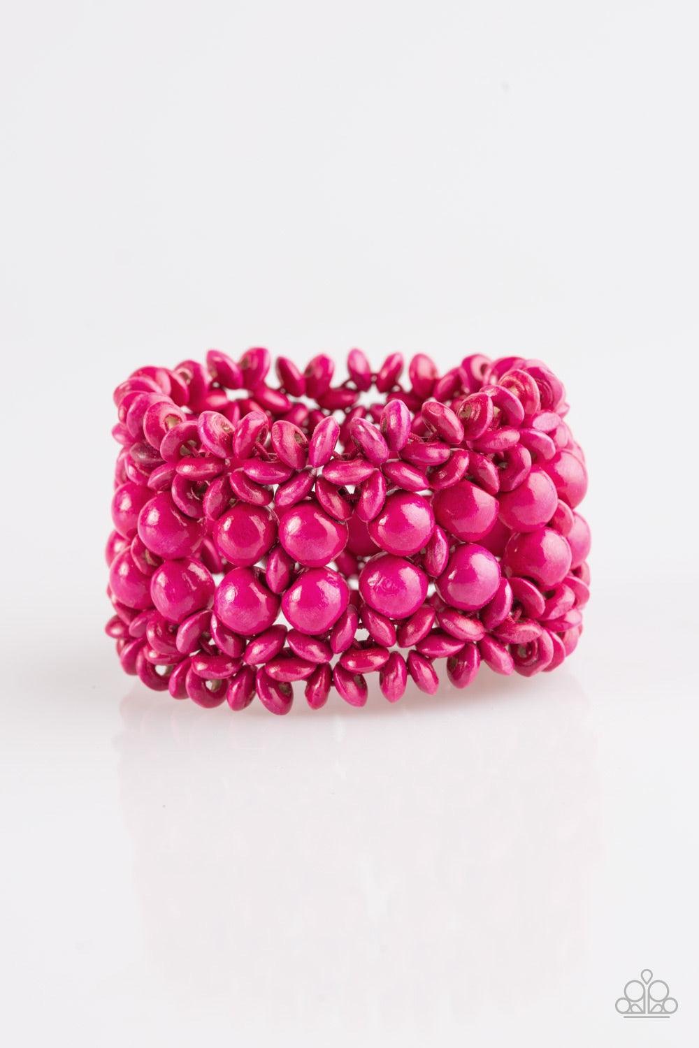 Paparazzi Accessories Tropical Bliss - Pink Pink wooden accents are threaded along elastic stretchy bands, creating an ornate bracelet. Rounded pink wooden beads line the center of the summery pattern for a bold finish. Jewelry