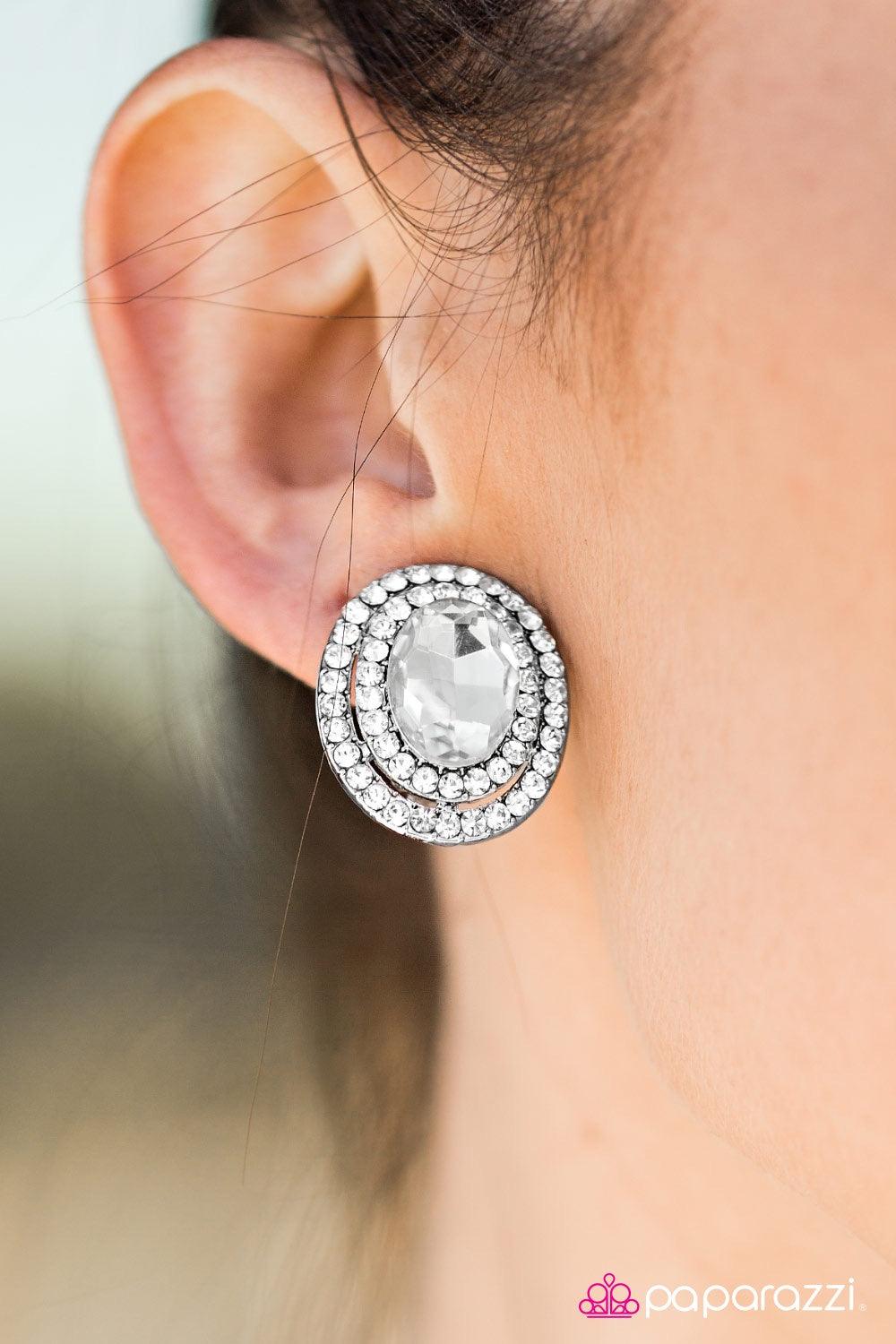 Paparazzi Accessories All For The Shimmer - White *Clip-On Two frames of dazzling white rhinestones spin around a glassy center, creating classic shimmer from any angle. Earring attaches to a standard clip-on fitting. Jewelry