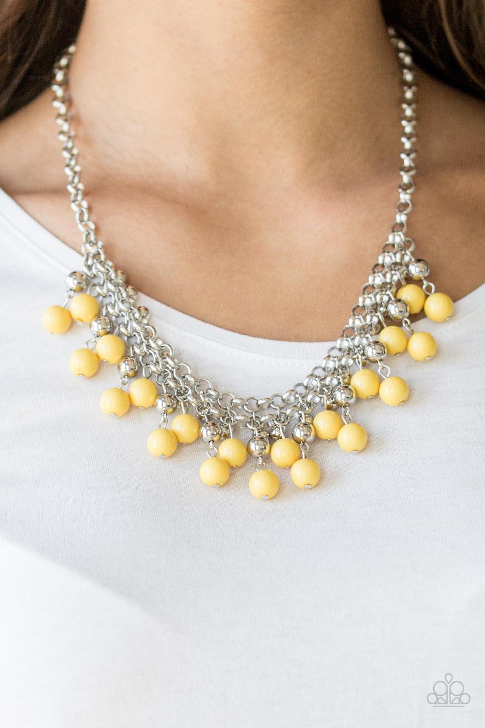 Paparazzi Accessories Friday Night Fringe - Yellow Rows of classic silver and sunny yellow beads trickle from two rows of interlocking silver chains, creating a bold colorful fringe below the collar. Features and adjustable clasp closure. Sold as one indi