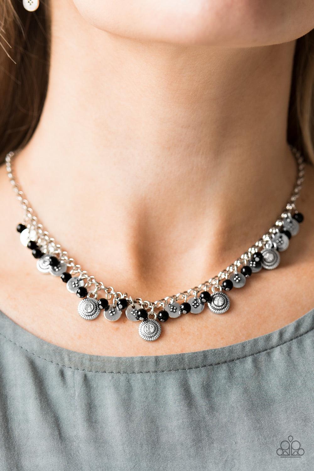 Paparazzi Accessories Fashion Formal - Black Dainty black beads and ornate silver discs swing from the bottom of a shimmery silver chain, creating a casual fringe below the collar. Featuring rhinestone centers, textured silver discs are sprinkled between