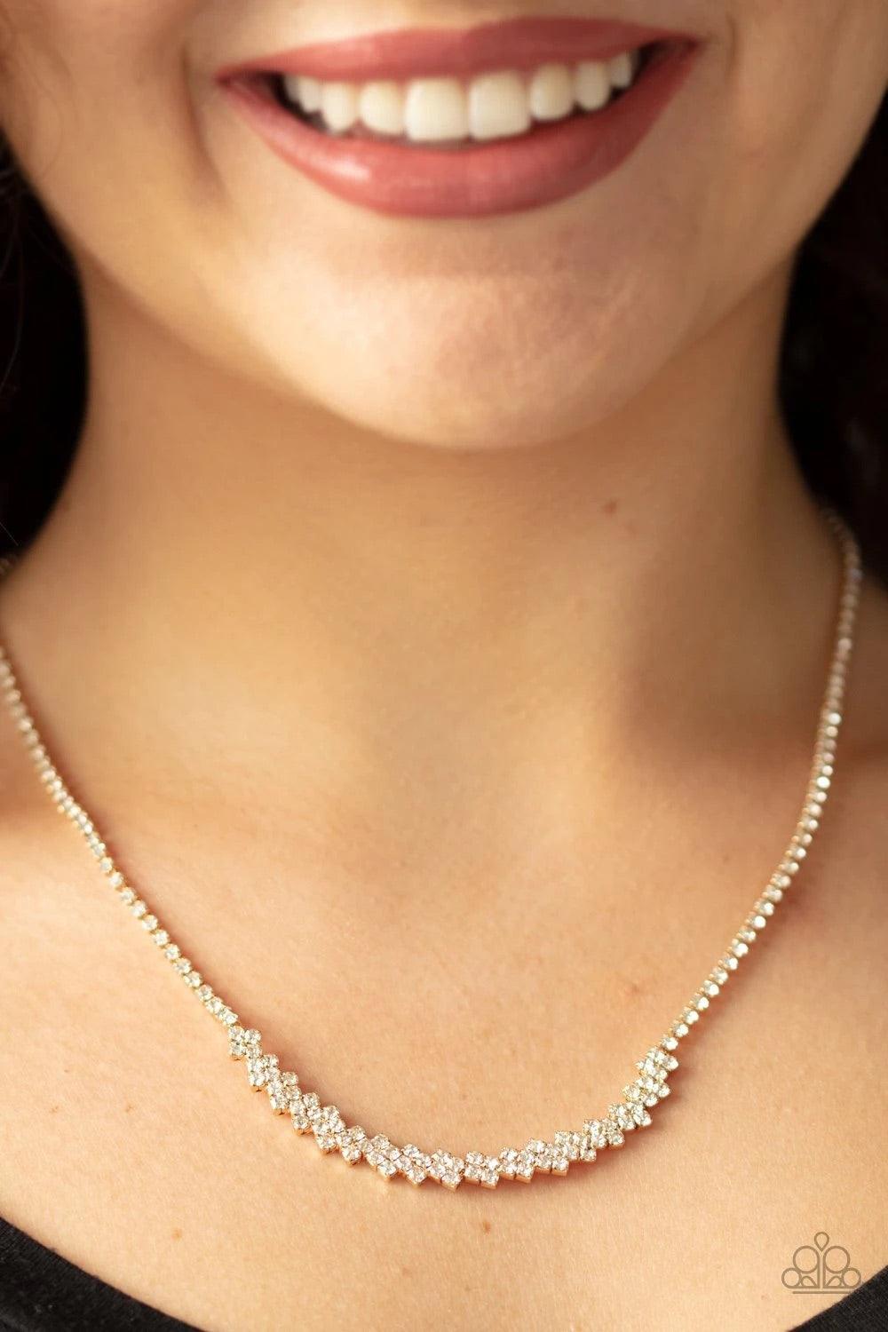 Paparazzi Accessories Glamour Glow - Gold A dainty strand of glittery white rhinestones attach to a bowing pendant encrusted in blinding white rhinestones, creating a glitzy look below the collar. Features an adjustable clasp closure. Sold as one individu