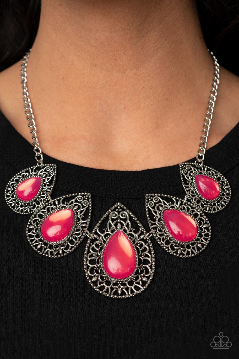 Paparazzi Accessories Opal Auras - Pink Featuring an opalescent shimmer, glassy pink teardrop beads are nestled inside shiny silver frames filled with vine-like antiqued filigree. Graduating in size, the whimsical frames delicately link below the collar f