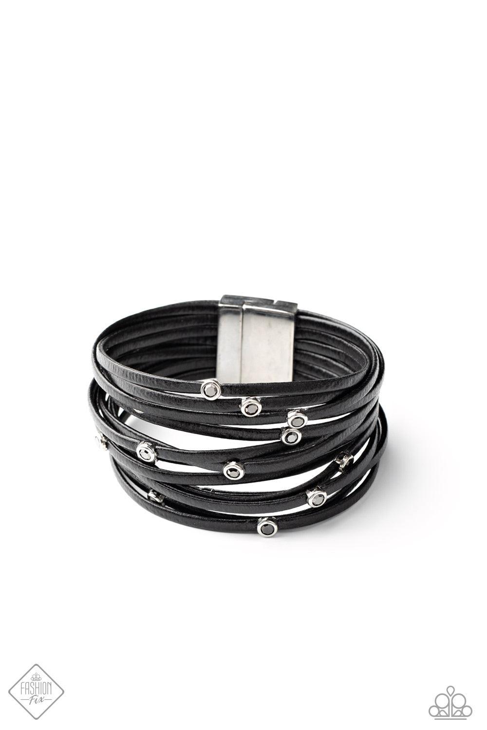 Paparazzi Accessories Fearlessly Layered ~Black Dotted with smoky hematite rhinestones, strands of black leather cording are strung between two silver fittings around the wrist in a fabulously layered finish. Features a magnetic closure. Sold as one indiv