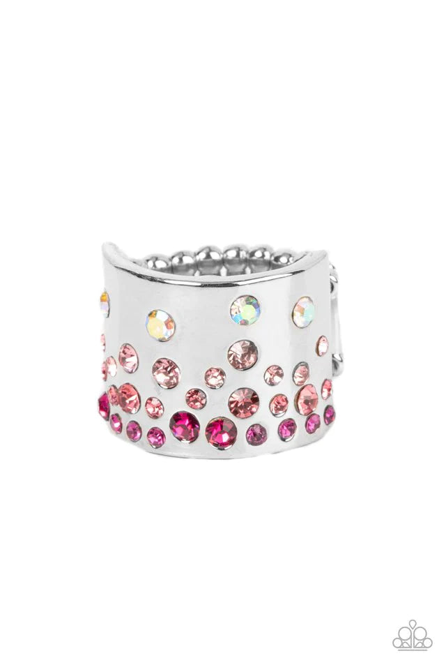 Paparazzi Accessories Sizzling Sultry - Pink Featuring iridescent and glassy finishes, glitzy rows of pink and multicolored rhinestones are haphazardly sprinkled across the front of a thick silver band for a colorful splash of ombre sparkle. Features a st