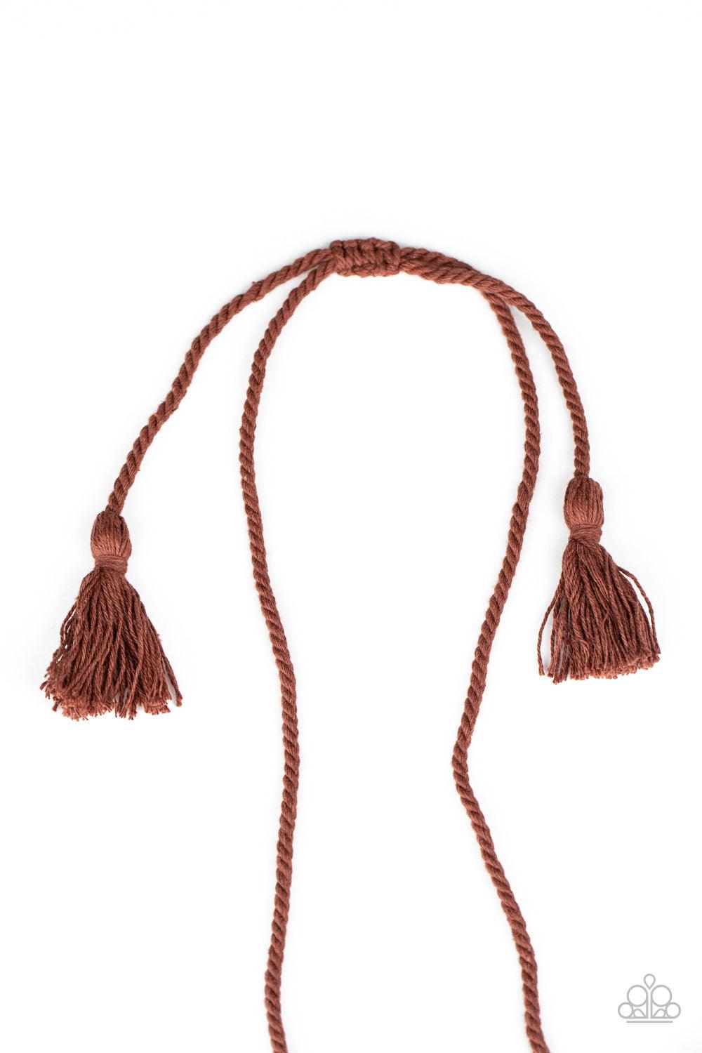 Paparazzi Accessories Macrame Mantra - Brown Brown twine-like cording decoratively knots into a macramé inspired pendant at the bottom of lengthened strands of twisted cording. Featuring frayed ends, excess cording streams from the bottom of the knotted c
