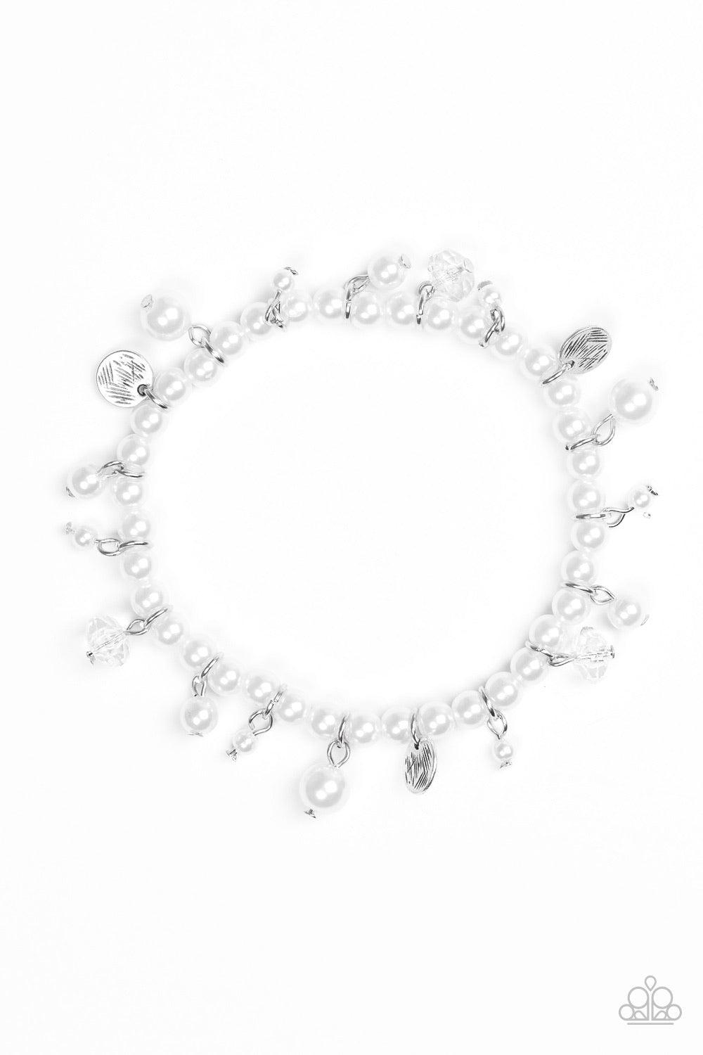 Paparazzi Accessories Treasure Chest Chic - White Classic white pearls are threaded along an elastic stretchy band. Etched in glistening textures, shimmery silver discs, pearl accents, and glittery crystal-like beading swing from the wrist, adding a refin