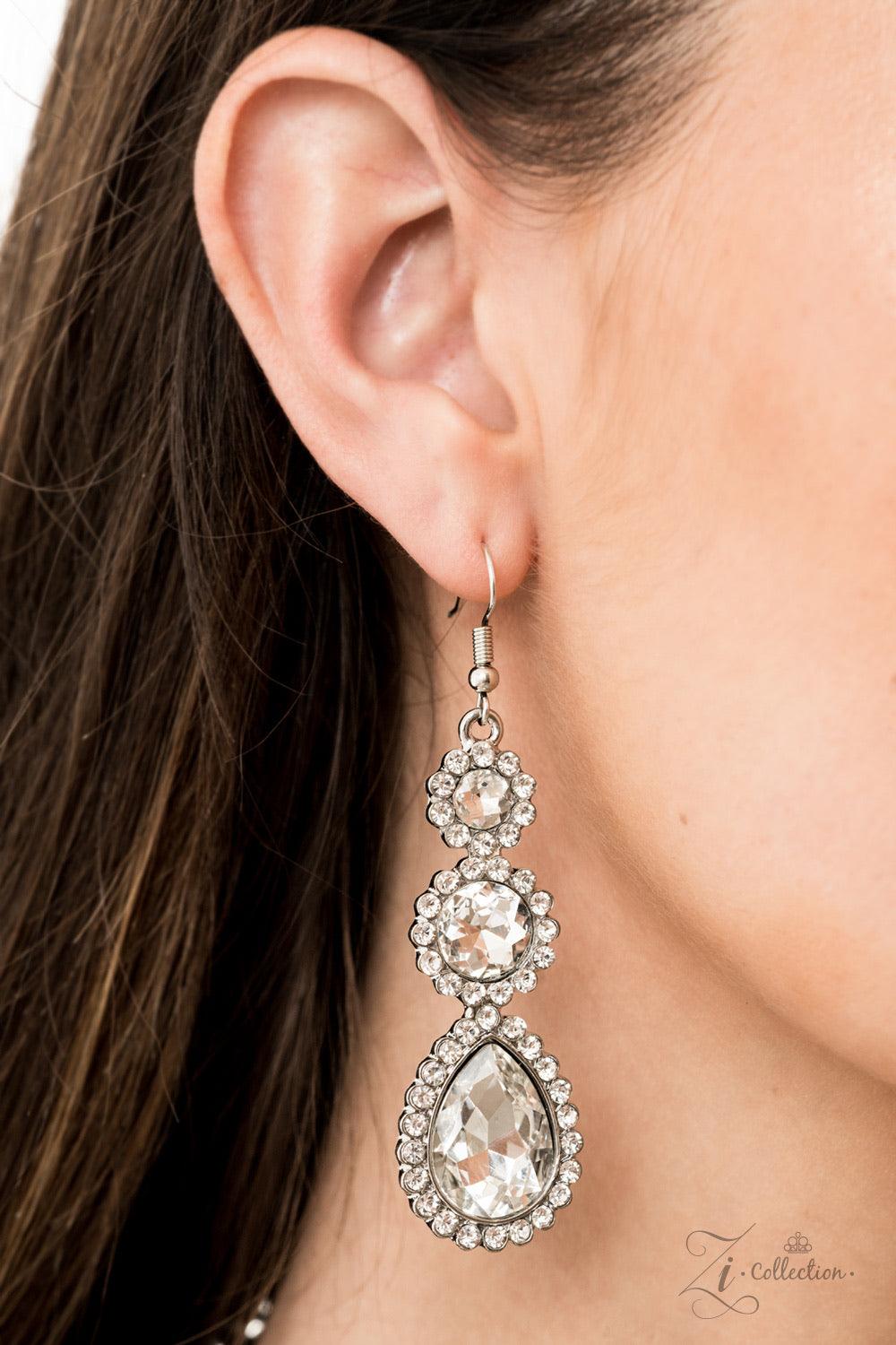 Paparazzi Accessories Mesmerize 💗ZiCollection $25💗 Encrusted in dainty white rhinestone frames, columns of glassy white gem studded frames increase in size as they drip below the collar. Varying in size and number, white rhinestone encrusted teardrop ge
