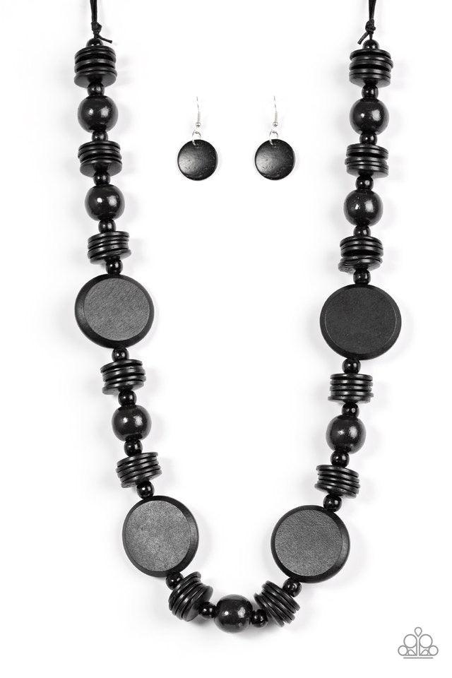 Paparazzi Accessories Tiki Tonga - Black Brushed in a shiny black finish, round wooden beads and discs are threaded along strands of black thread. Dramatic wooden accents are sprinkled between the stacked beading, adding bold earthy accents to the summery