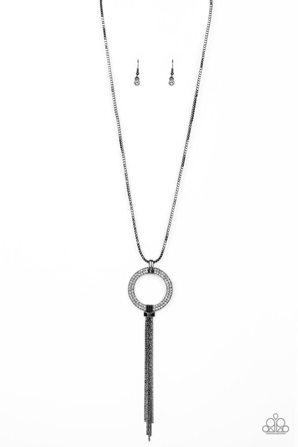 Paparazzi Accessories Not A HEIR Out Of Place - Black Encrusted in blinding white rhinestones, a sparkling gunmetal ring swings from the bottom of a lengthened gunmetal box chain. Flattened gunmetal chains stream from the bottom of the glittery pendant fo