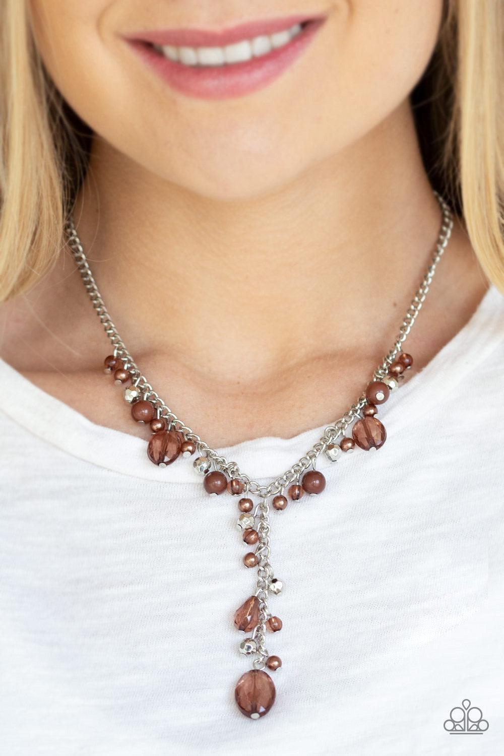Paparazzi Accessories Crystal Couture - Brown Mismatched polished brown beads, crystal-like beads, and faceted silver beads dance along a shimmery silver chain. Matching beading trickles along a single silver chain, creating a romantic extended pendant be